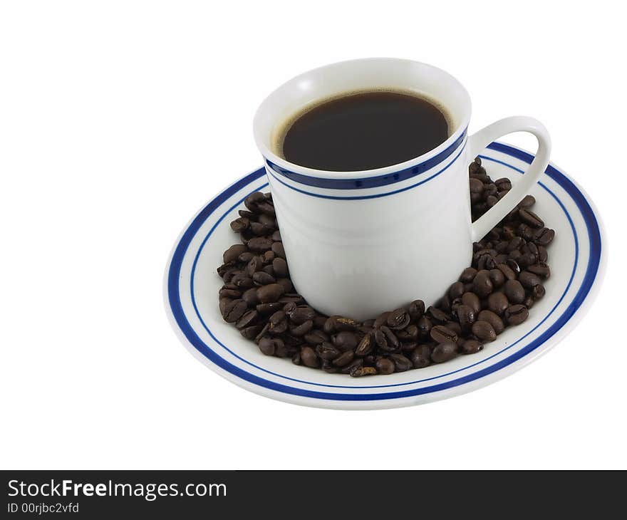 Cup of coffee on a plate with coffee beans, isolated on white