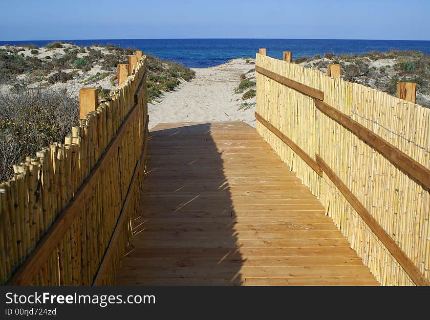 A pathway leads to a beautiful beach. Sardinia beach. A pathway leads to a beautiful beach. Sardinia beach.