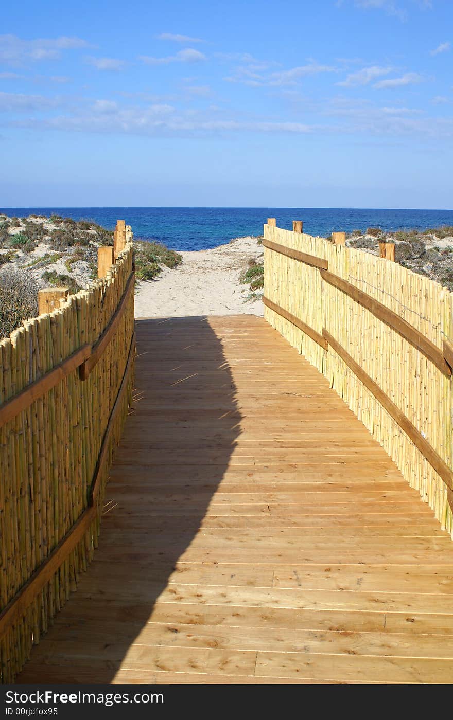 A pathway leads to a beautiful beach. Sardinia beach. A pathway leads to a beautiful beach. Sardinia beach.