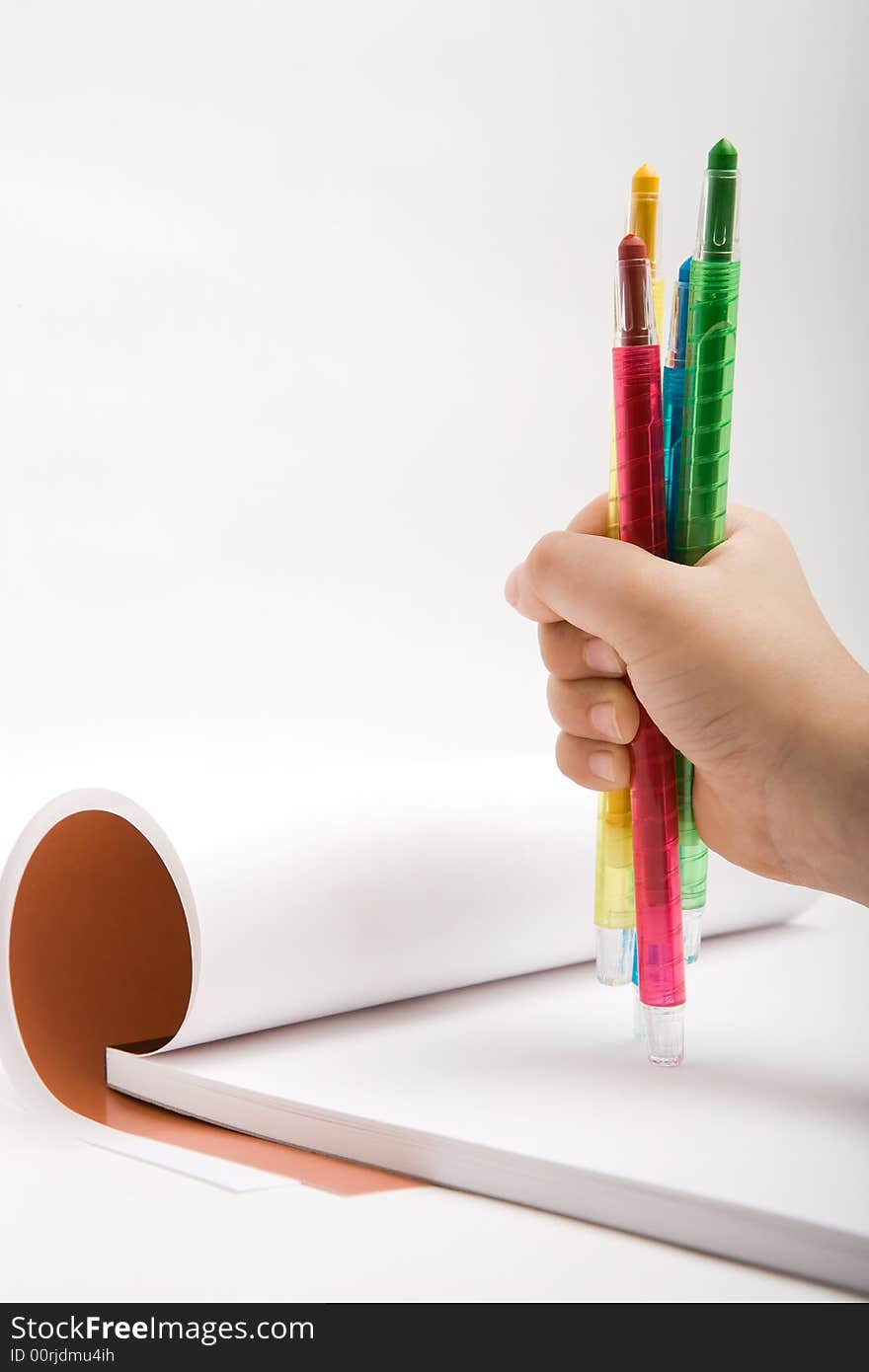 Colored pencils in the children's hand. Colored pencils in the children's hand