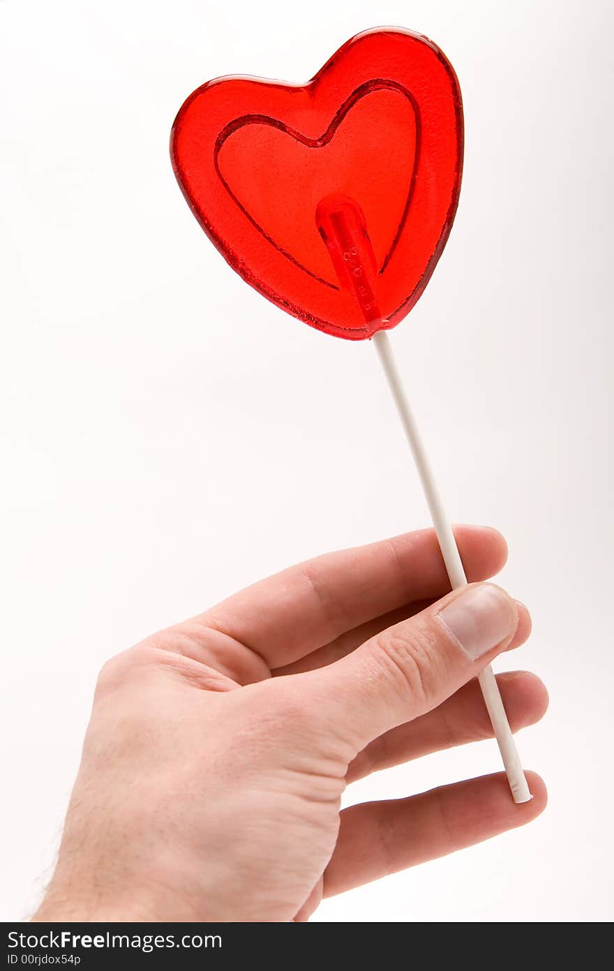 Love - Heart shape lollipop in a man's hand