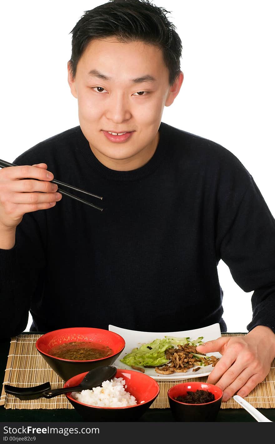 Young men eats asian food, isolated on a white background. Young men eats asian food, isolated on a white background.