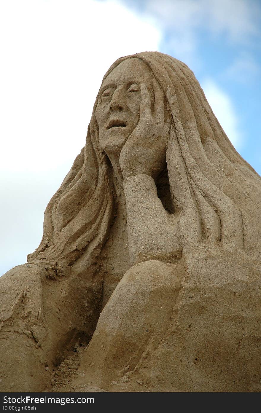 Sand sculpture of a sad woman. Sand sculpture of a sad woman