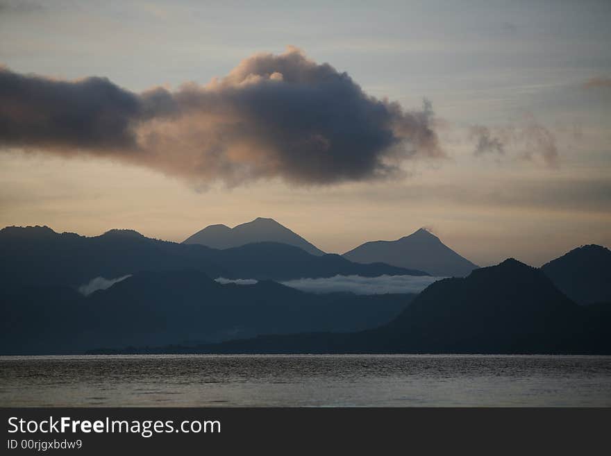 Clouds over mountains and lake