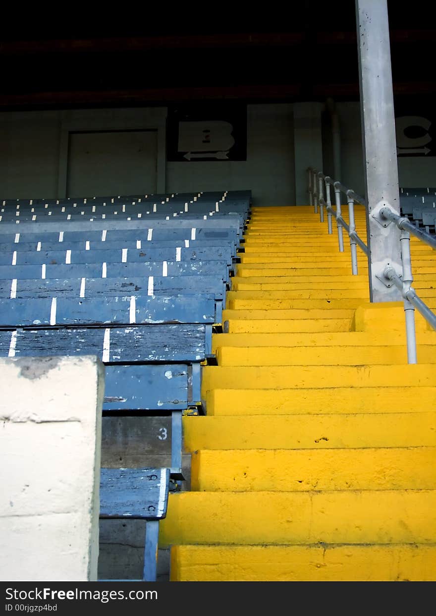 Vertical shot of a yellow staircase ascending into the grand stands at the state fairgrounds.