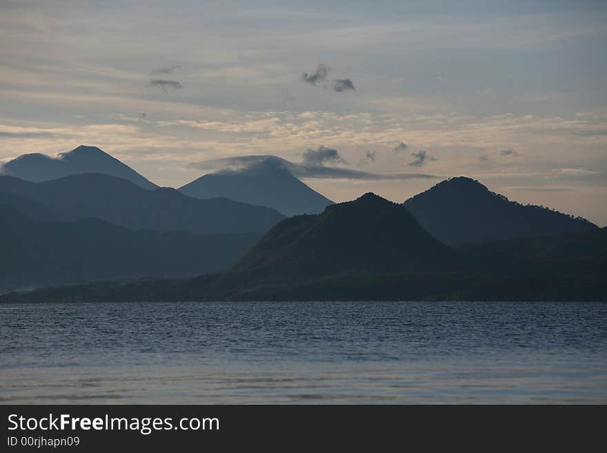 Clouds over mountains and lake