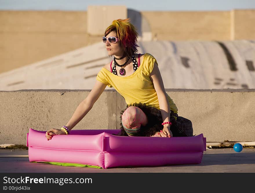 Portrait of a Punk Girl with Bright Colorful and Big Sunglasses Outdoors at Sundown. Portrait of a Punk Girl with Bright Colorful and Big Sunglasses Outdoors at Sundown