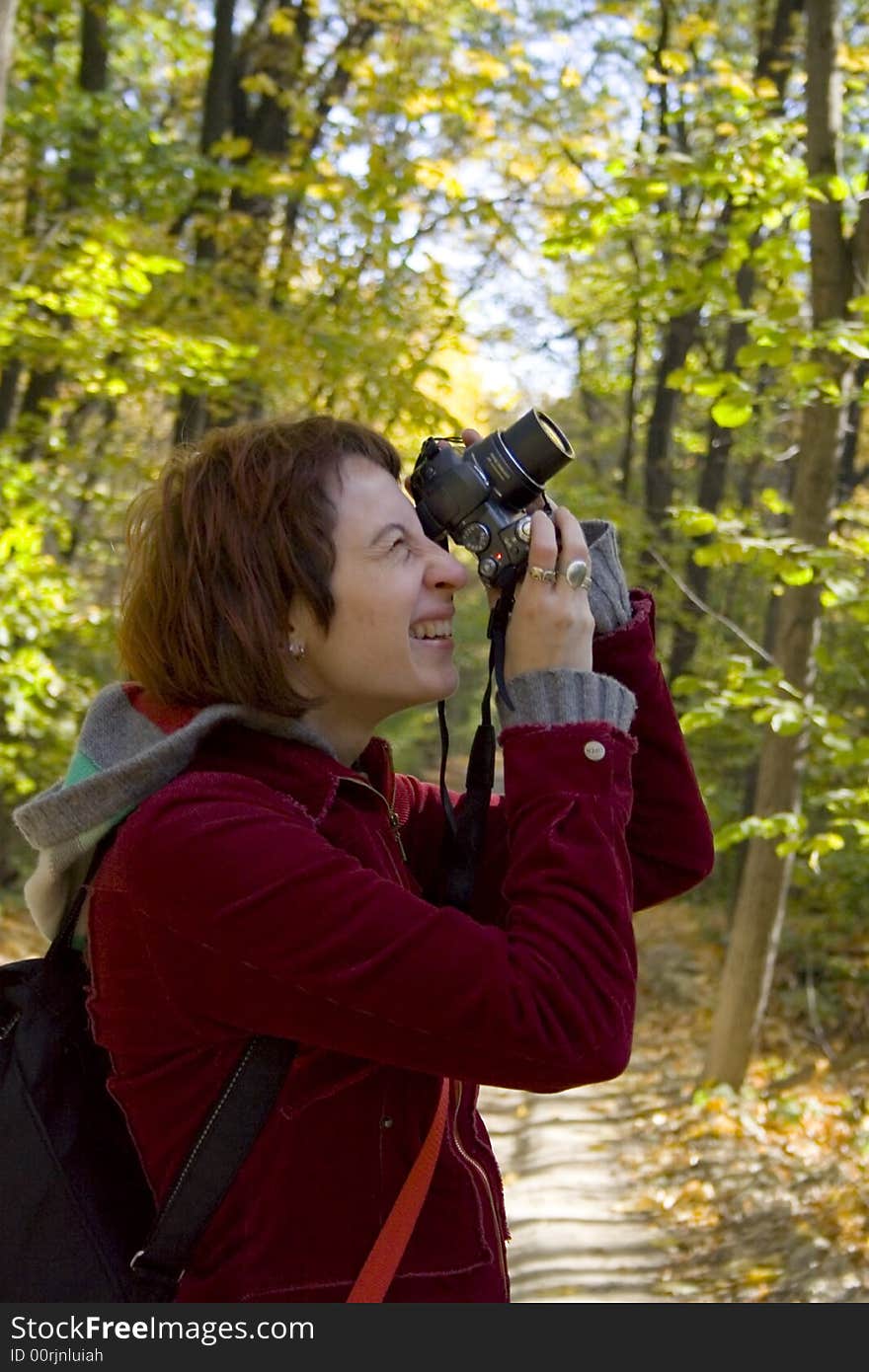 The girl photographes, the camera to photograph a wood. The girl photographes, the camera to photograph a wood