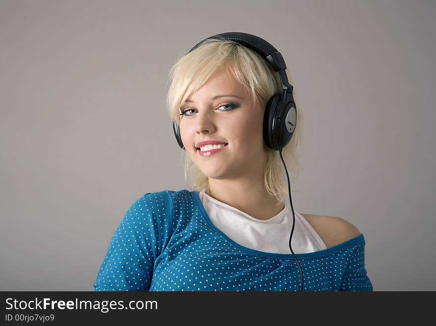 Caucasian woman listening to headphones. Caucasian woman listening to headphones