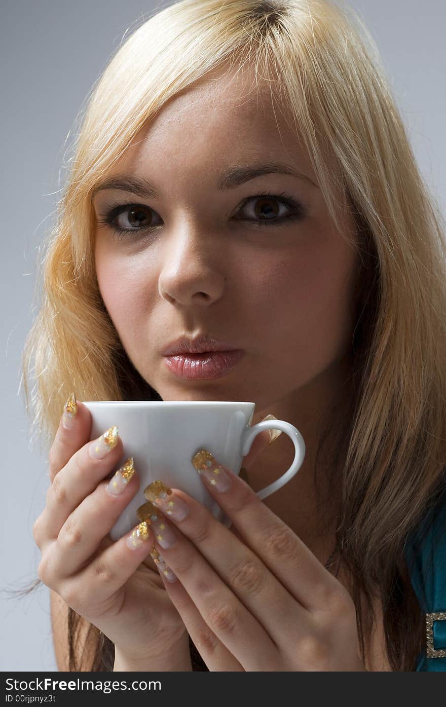 Girl keeping  the cup in palms. Girl keeping  the cup in palms