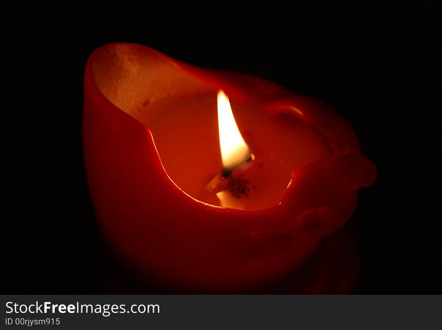 A candle on black background