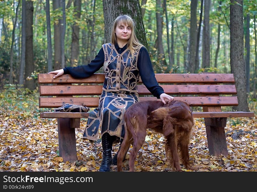 Portrait of the beautiful girl and irish setter in autumn forest. Portrait of the beautiful girl and irish setter in autumn forest.