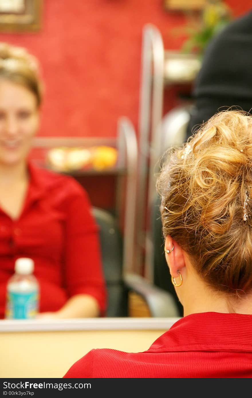 Attractive young Caucasian blonde woman having hair styled for special event. Attractive young Caucasian blonde woman having hair styled for special event