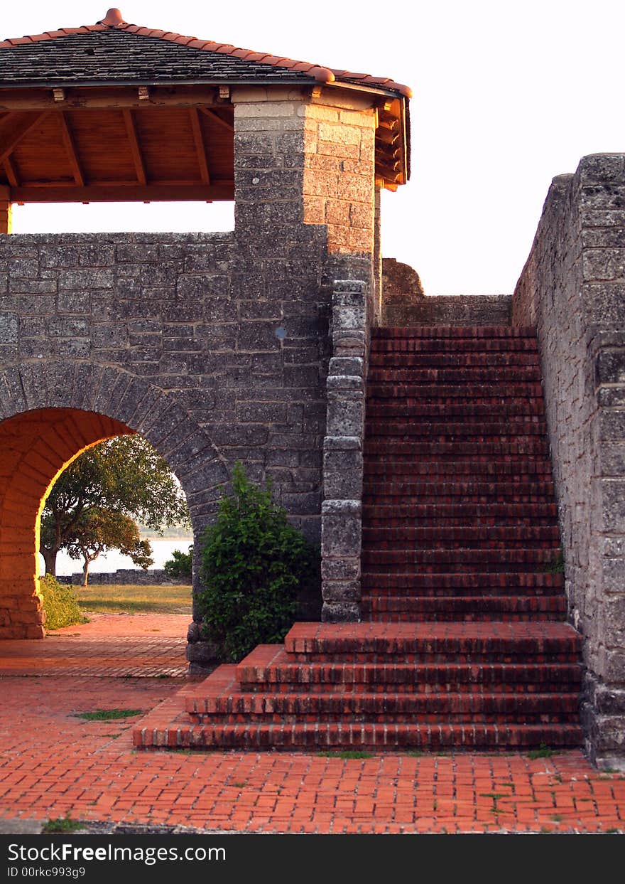 Red brick stairs surrounded by gray stone walls. Red brick stairs surrounded by gray stone walls