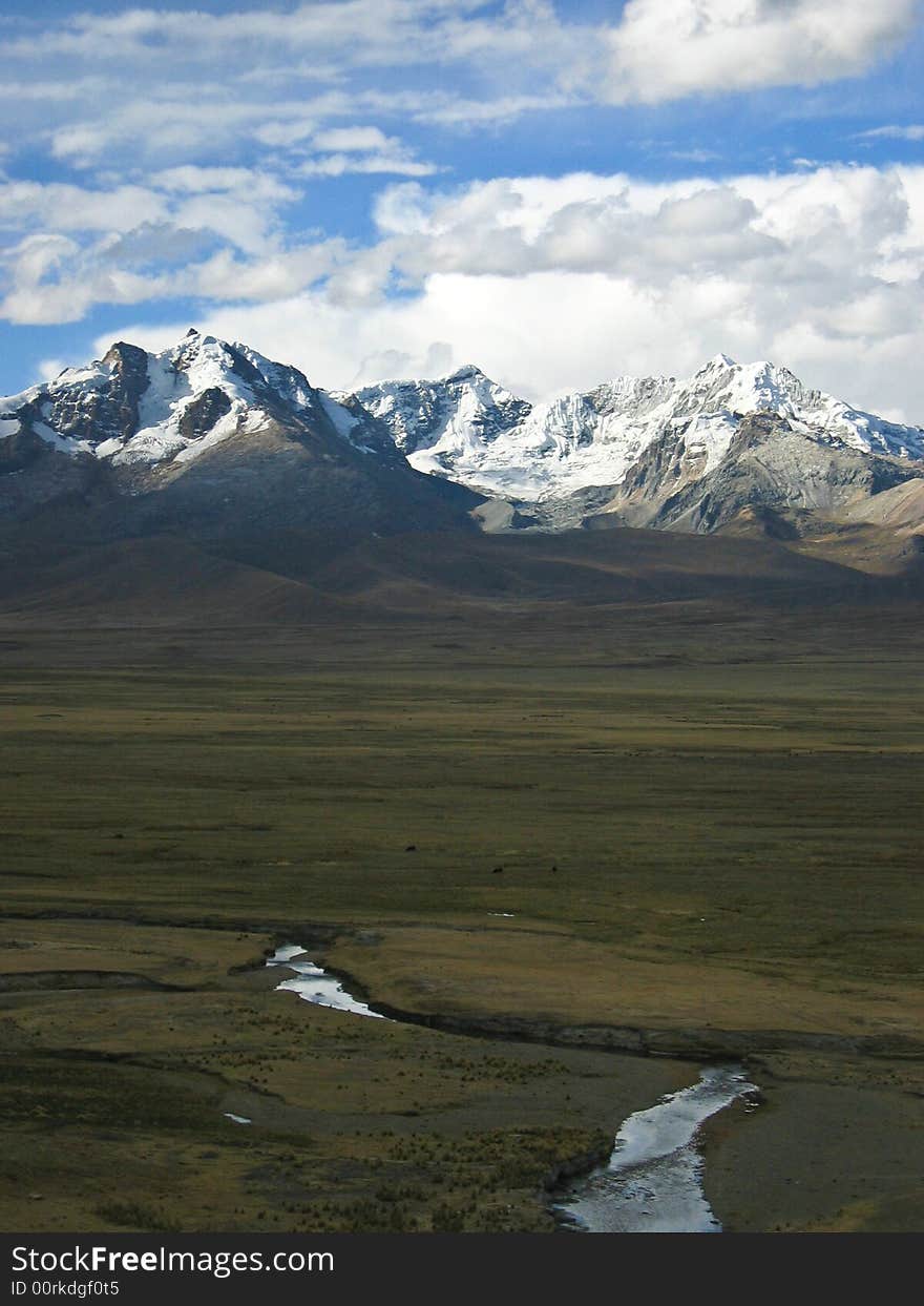 Stream leading to snowy peaks