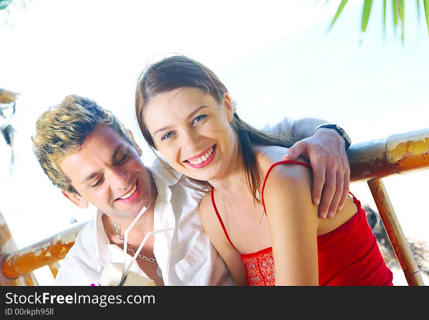 A portrait of attractive couple having date on the beach. A portrait of attractive couple having date on the beach