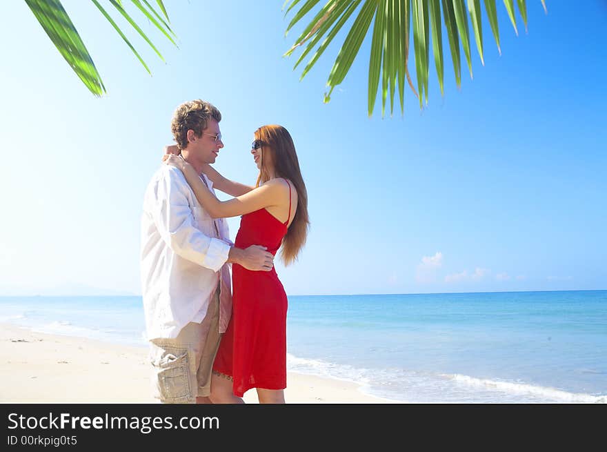 A portrait of attractive couple having date on the beach. A portrait of attractive couple having date on the beach