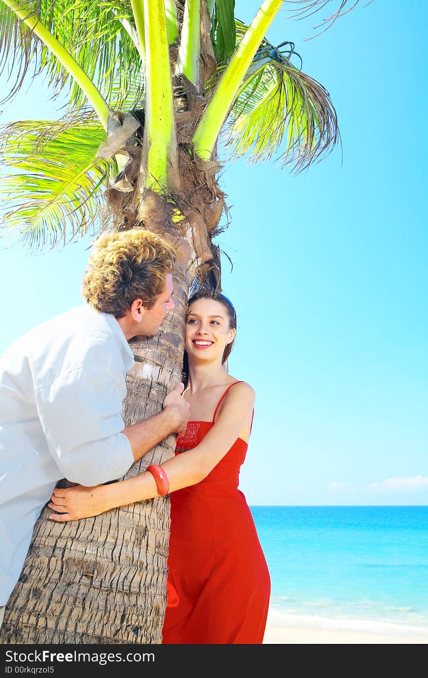 A portrait of attractive couple having date on the beach. A portrait of attractive couple having date on the beach