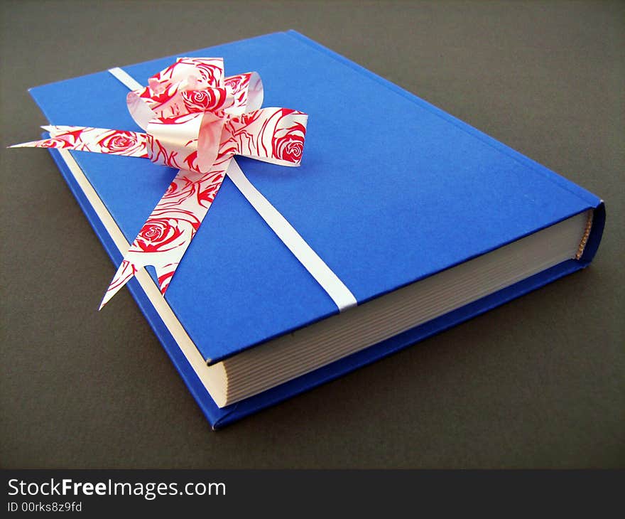 Present book with bow on white