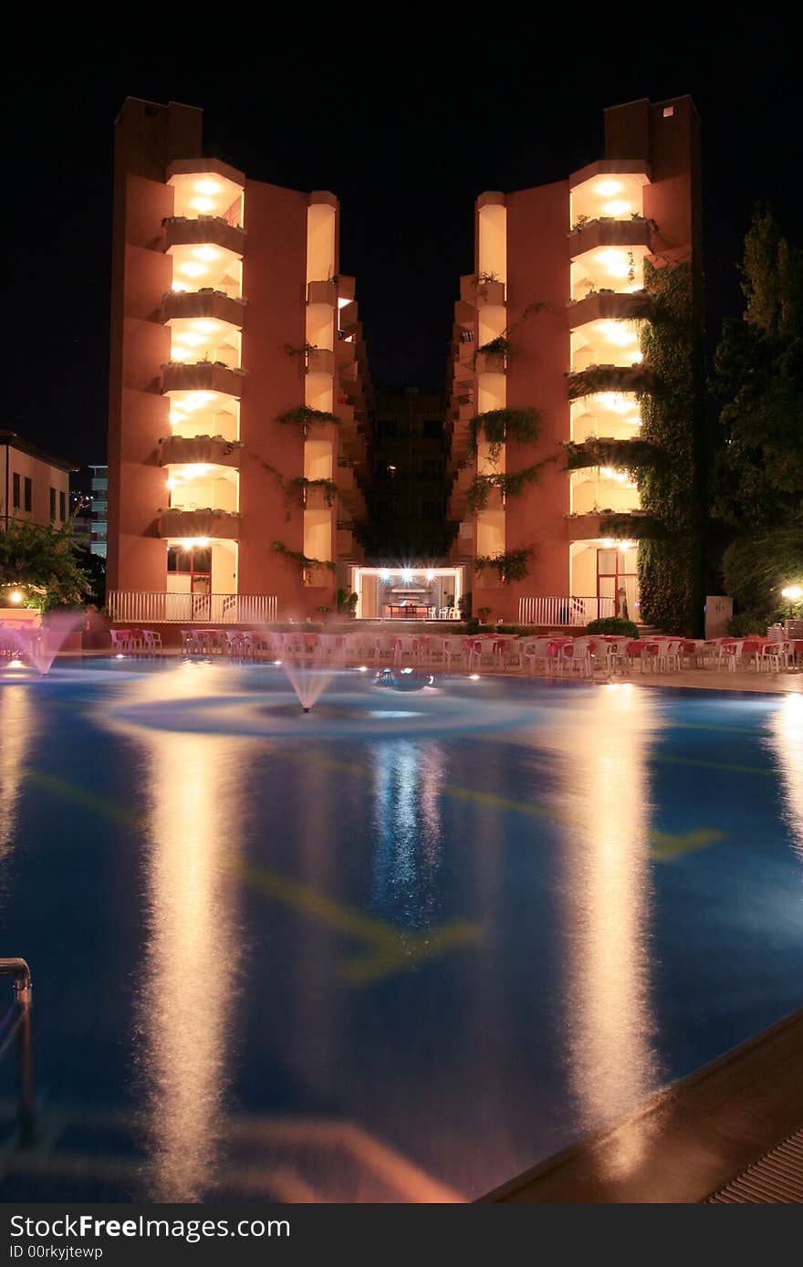 Hotel, pool and fountain at night