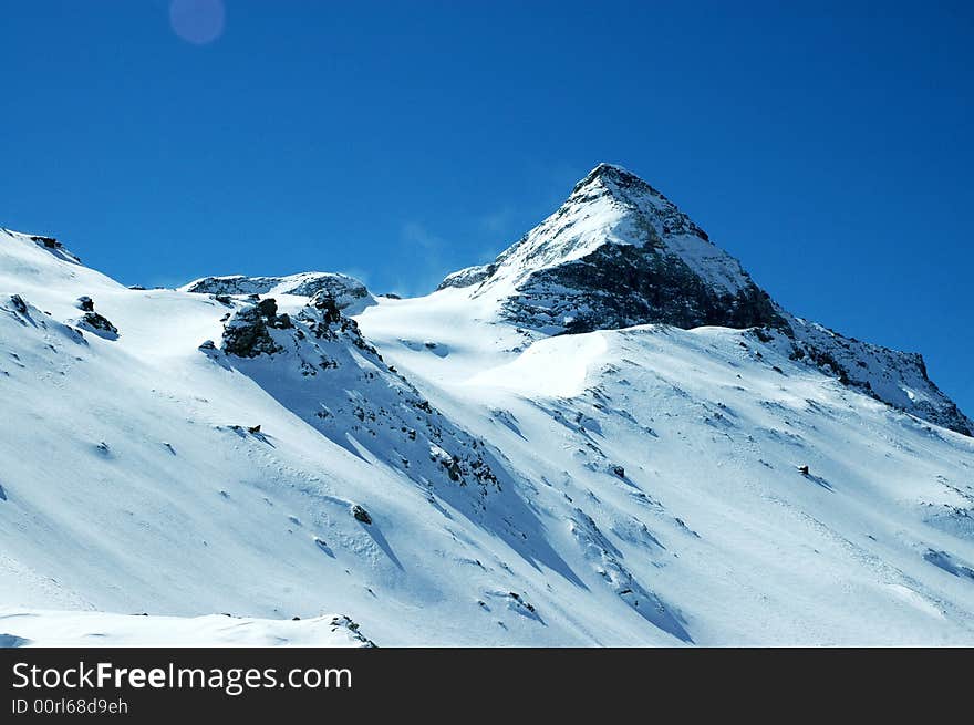 Snowy mountain on sunny winter day in Italian Alps. Snowy mountain on sunny winter day in Italian Alps