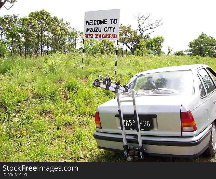 This is a welcome sign The small city known as Mzuzu. The allowed speed is 80 Km per hour. This is a welcome sign The small city known as Mzuzu. The allowed speed is 80 Km per hour.