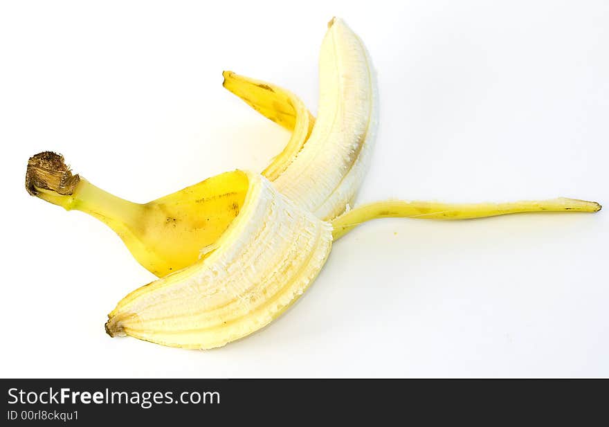 Peeled and whole banana with and without tomatos on glass plate on white background. Peeled and whole banana with and without tomatos on glass plate on white background