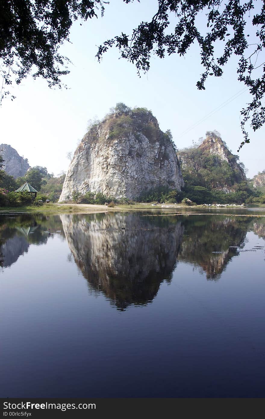 Rocky mountain cliff reflect on the surface of the lake. Rocky mountain cliff reflect on the surface of the lake