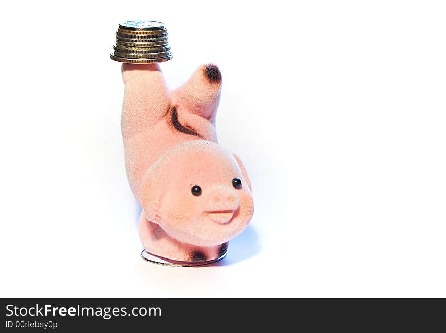 Finger puppet in the shape of a pig, balancing coins on a finger. Finger puppet in the shape of a pig, balancing coins on a finger.