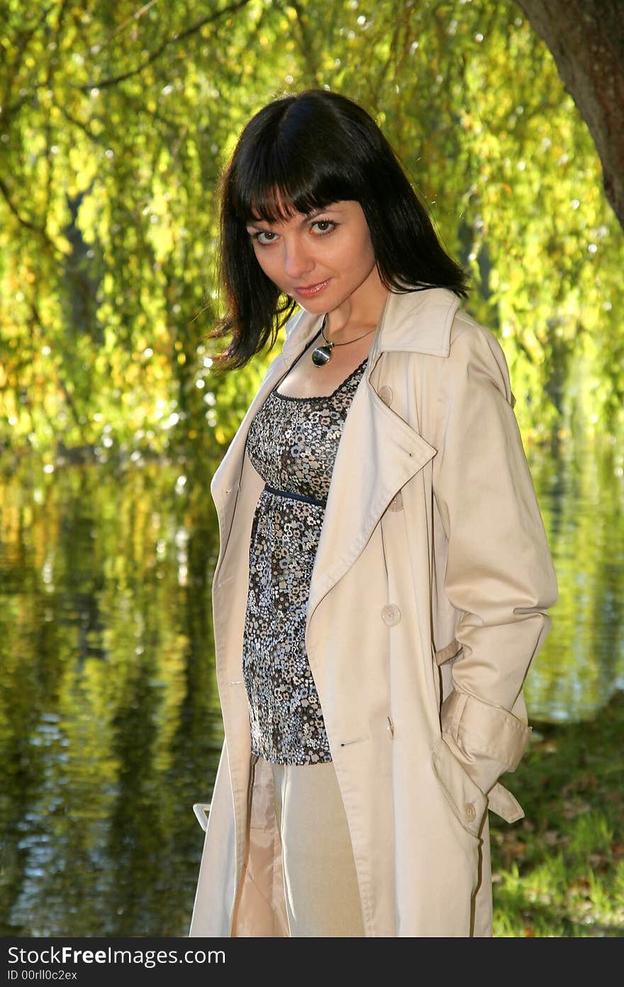 Beautiful woman staying in front of the lake. Beautiful woman staying in front of the lake