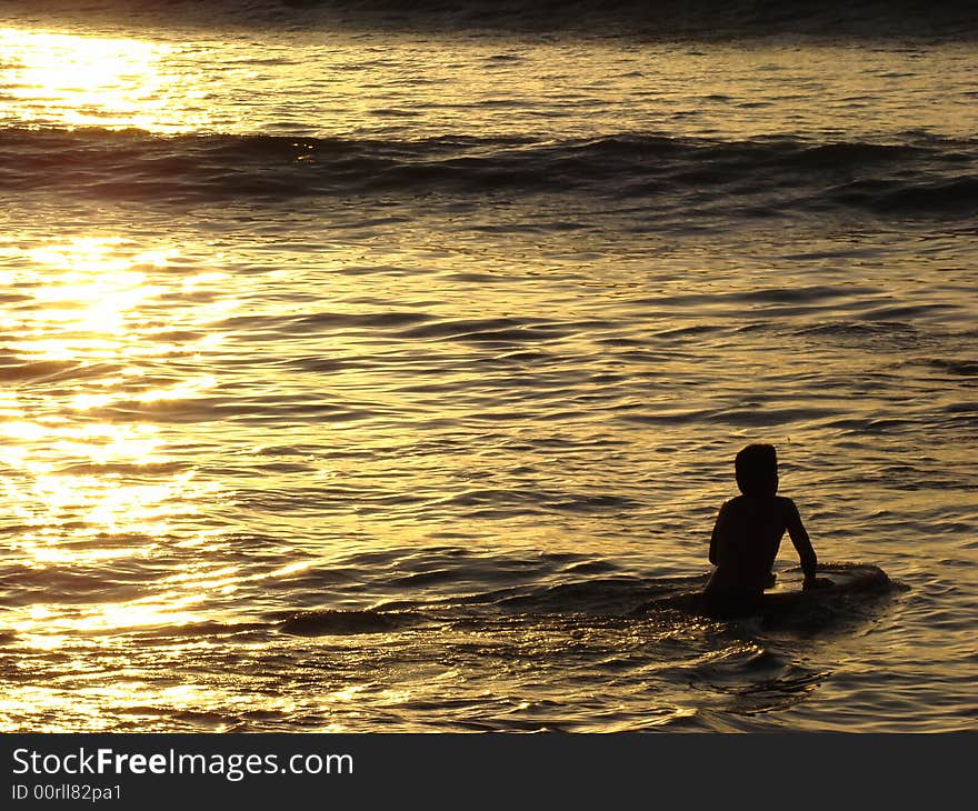 Surfer In The Sunset