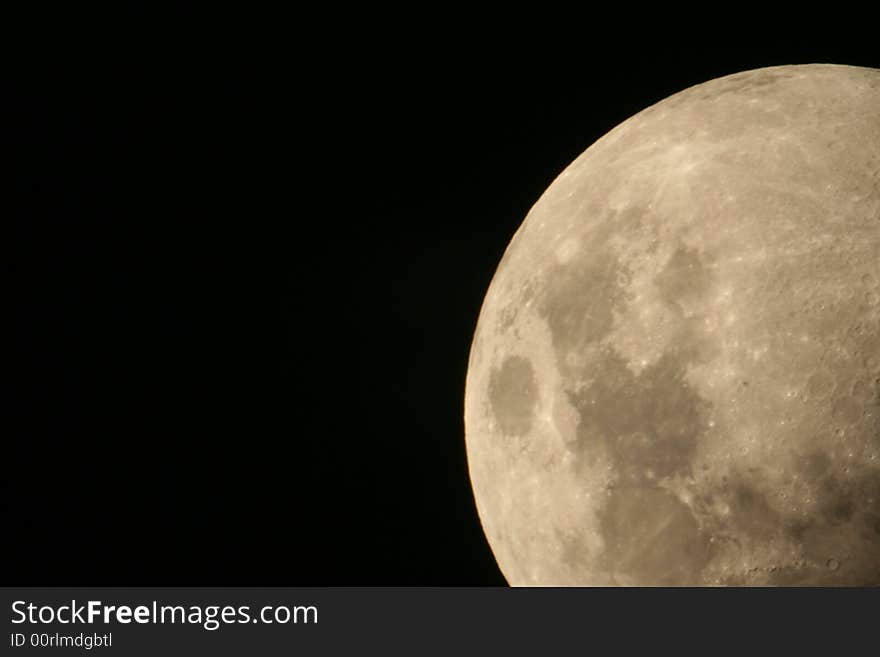 Closeup rising moon, with visible craters