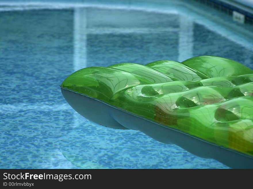 Inflatable bed floating on private swiming pool