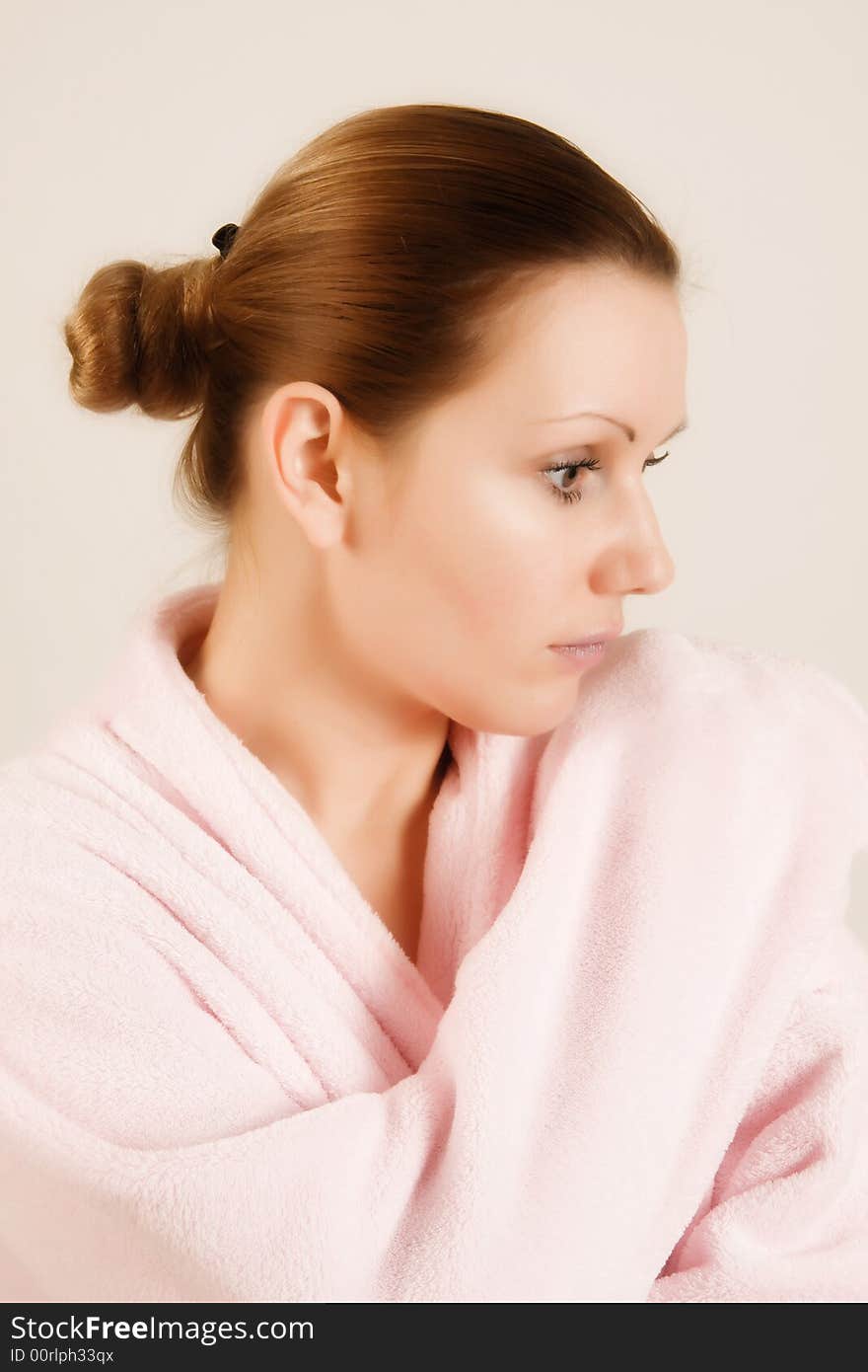 Beautiful woman in pink bathrobe