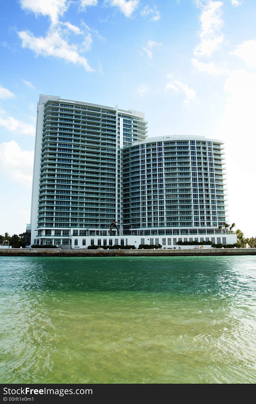 Luxurious high rise Condominiums with deep blue sky background and water foreground. Luxurious high rise Condominiums with deep blue sky background and water foreground