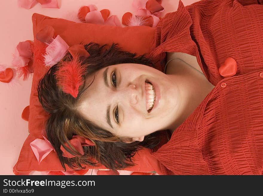 Young beautiful woman  on a red pillow