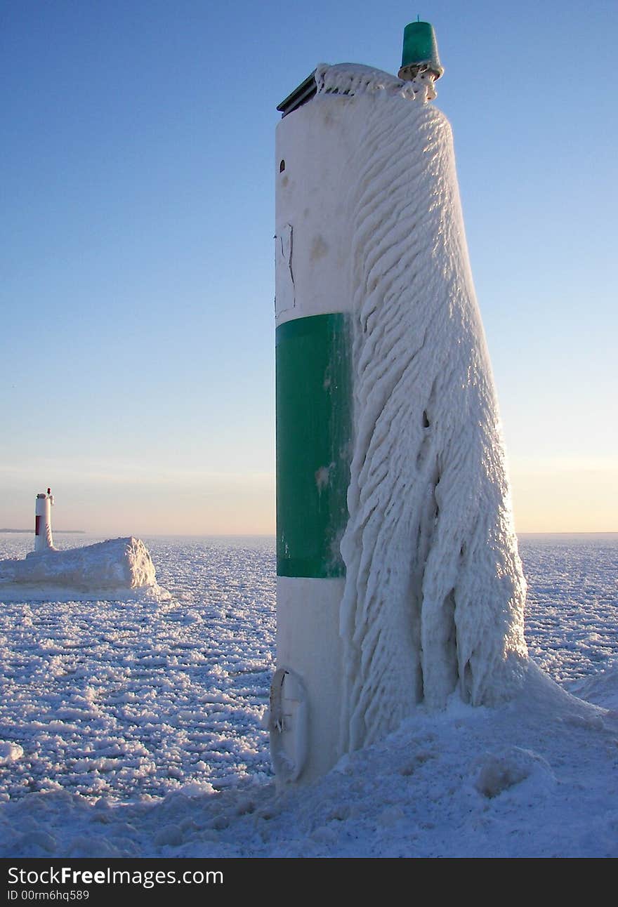 Icy buildup on a channerl marker creating a unique design. Icy buildup on a channerl marker creating a unique design.