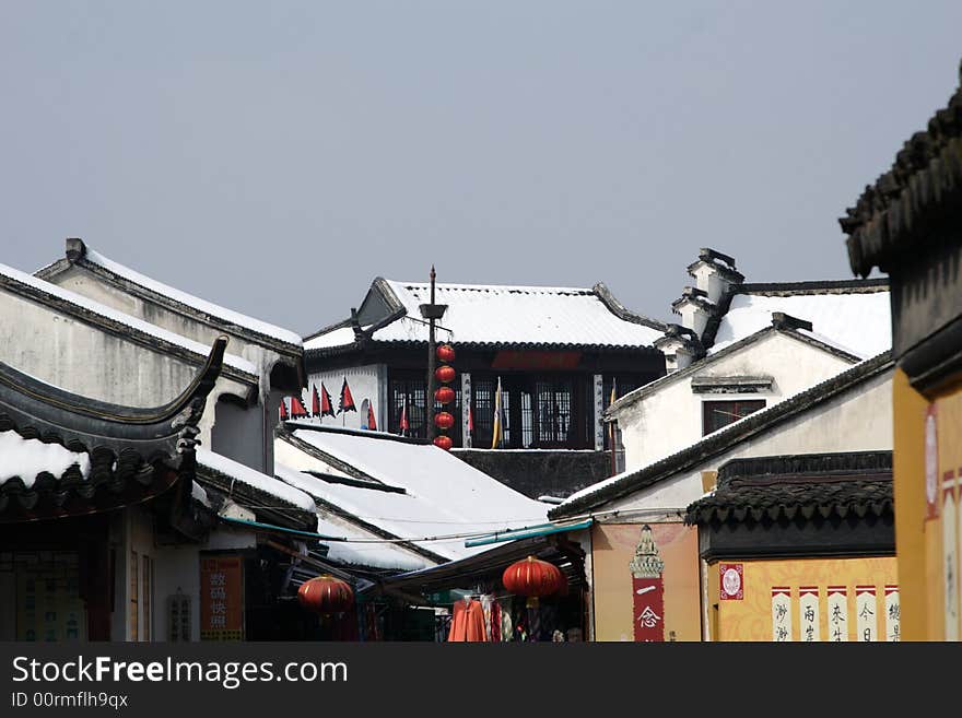 The beautiful and enjoyable snow scenery in the winter in the southern part of China. These sceneries are famous for their snow ,water, houses,and the blue sky.They are typical of the south in China.This picture is taken in the place of interest“Mooring by the Feng Bridge at night” in Suzhou ,China.