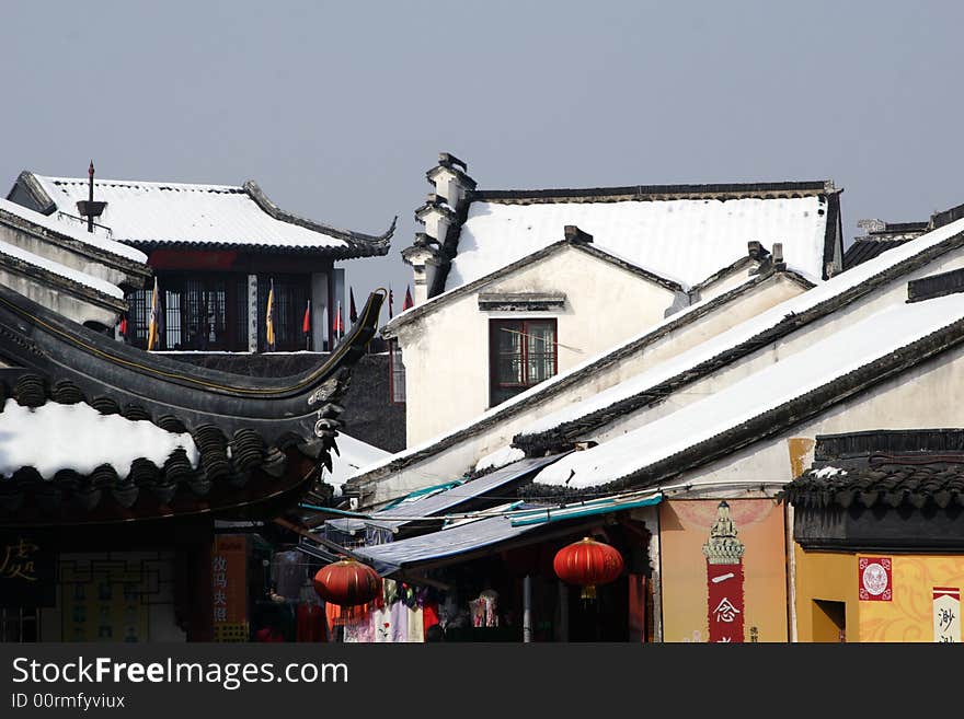 The beautiful and enjoyable snow scenery in the winter in the southern part of China. These sceneries are famous for their snow ,water, houses,and the blue sky.They are typical of the south in China.This picture is taken in the place of interest“Mooring by the Feng Bridge at night” in Suzhou ,China.