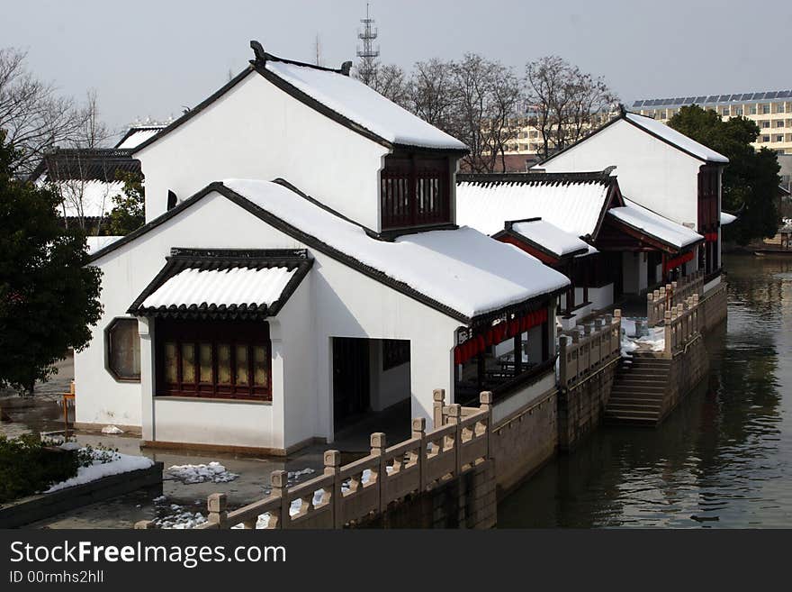 The beautiful and enjoyable snow scenery in the winter in the southern part of China. These sceneries are famous for their snow ,water, houses,and the blue sky.They are typical of the south in China.This picture is taken in the place of interest“Mooring by the Feng Bridge at night” in Suzhou ,China.