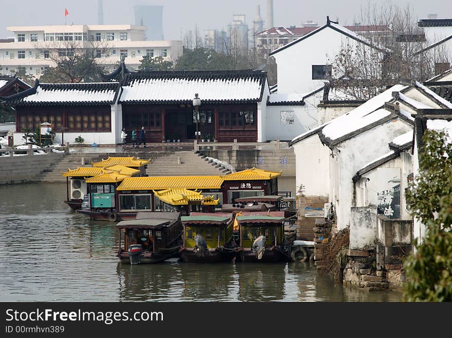 The beautiful and enjoyable snow scenery in the winter in the southern part of China. These sceneries are famous for their snow ,water, houses,and the blue sky.They are typical of the south in China.This picture is taken in the place of interest“Mooring by the Feng Bridge at night” in Suzhou ,China.