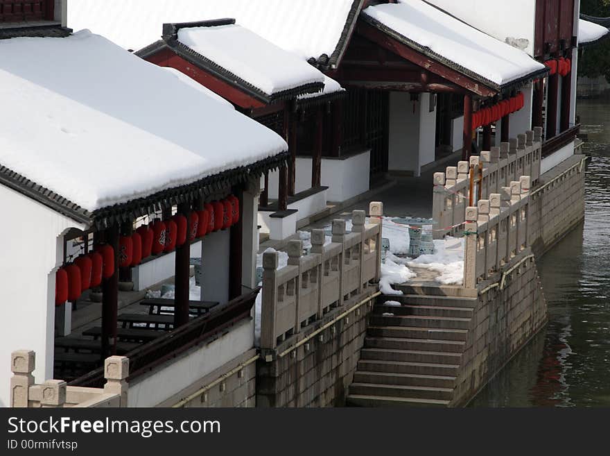 The beautiful and enjoyable snow scenery in the winter in the southern part of China. These sceneries are famous for their snow ,water, houses,and the blue sky.They are typical of the south in China.This picture is taken in the place of interest“Mooring by the Feng Bridge at night” in Suzhou ,China.