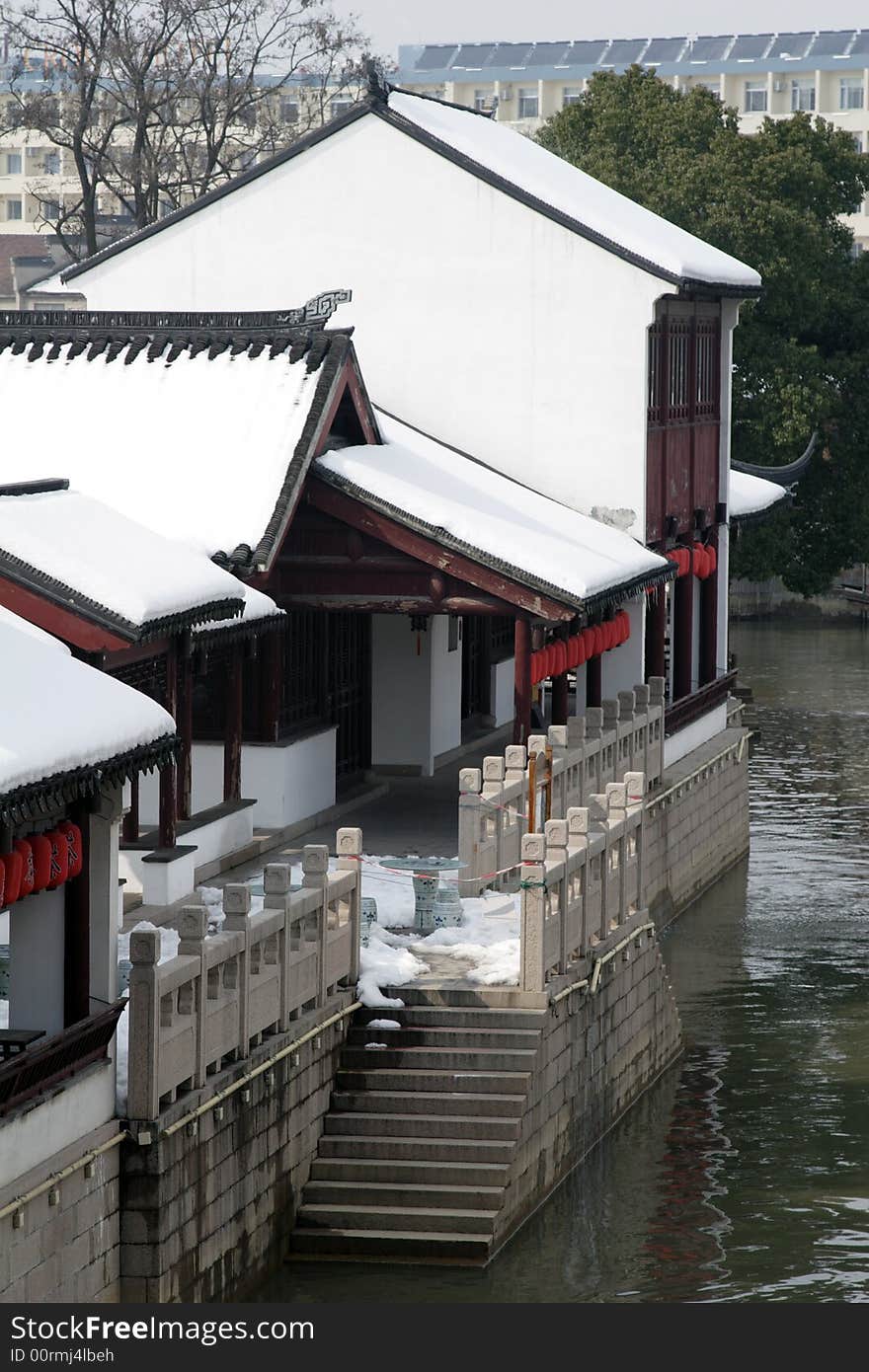 The beautiful and enjoyable snow scenery in the winter in the southern part of China. These sceneries are famous for their snow ,water, houses,and the blue sky.They are typical of the south in China.This picture is taken in the place of interest“Mooring by the Feng Bridge at night” in Suzhou ,China.