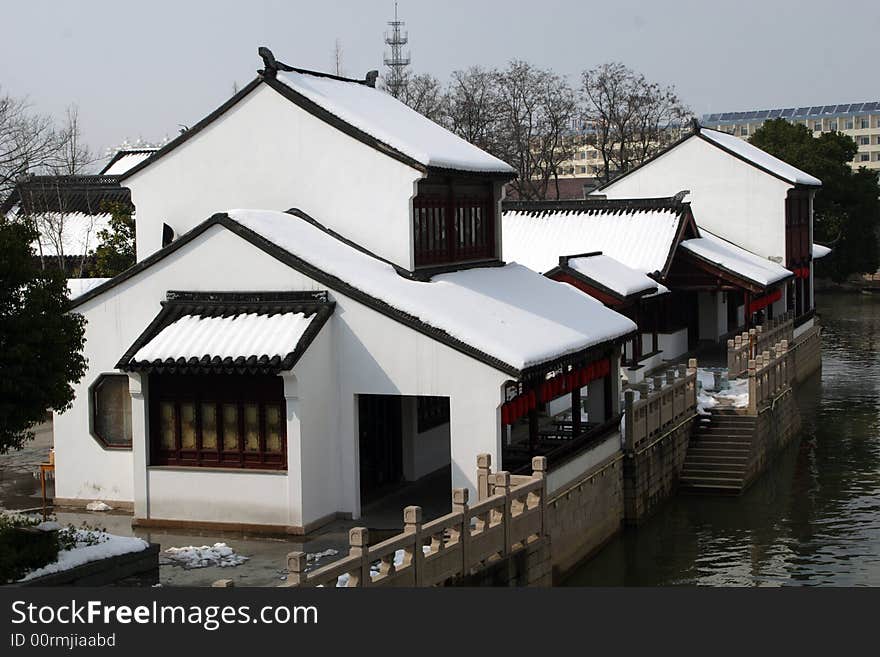 The beautiful and enjoyable snow scenery in the winter in the southern part of China. These sceneries are famous for their snow ,water, houses,and the blue sky.They are typical of the south in China.This picture is taken in the place of interest“Mooring by the Feng Bridge at night” in Suzhou ,China.