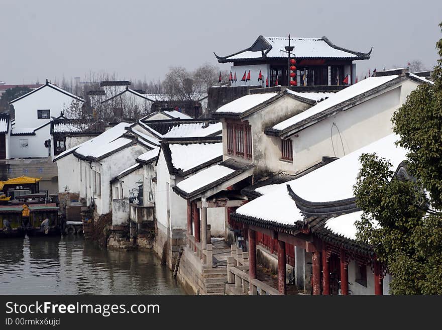 The beautiful and enjoyable snow scenery in the winter in the southern part of China. These sceneries are famous for their snow ,water, houses,and the blue sky.They are typical of the south in China.This picture is taken in the place of interest“Mooring by the Feng Bridge at night” in Suzhou ,China.