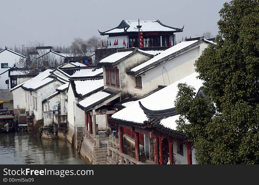 The beautiful and enjoyable snow scenery in the winter in the southern part of China. These sceneries are famous for their snow ,water, houses,and the blue sky.They are typical of the south in China.This picture is taken in the place of interest“Mooring by the Feng Bridge at night” in Suzhou ,China.