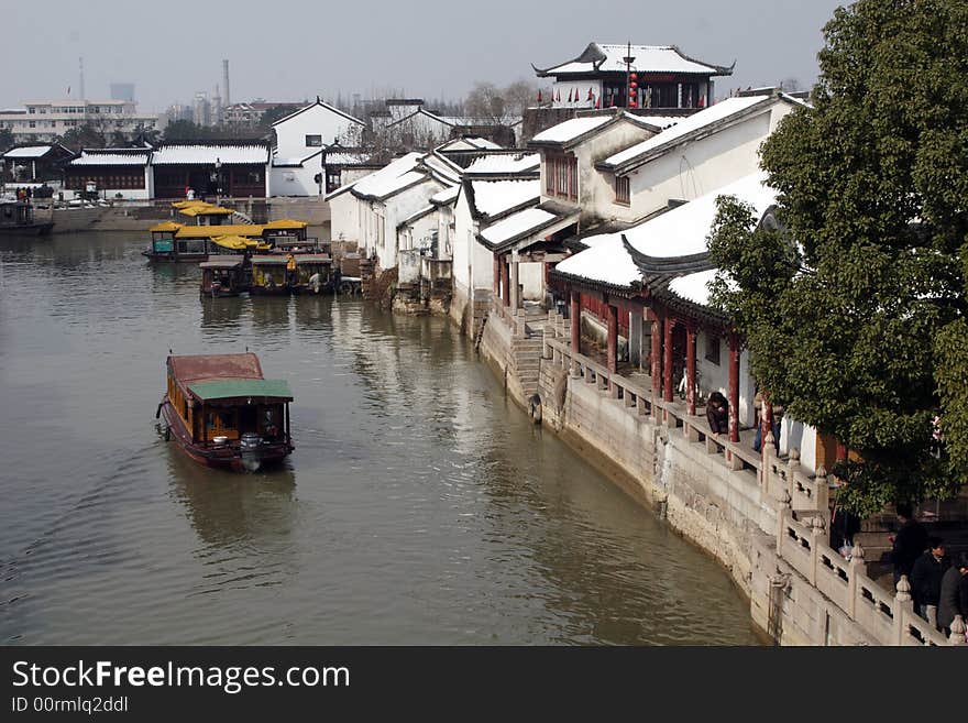 The beautiful and enjoyable snow scenery in the winter in the southern part of China. These sceneries are famous for their snow ,water, houses,and the blue sky.They are typical of the south in China.This picture is taken in the place of interest“Mooring by the Feng Bridge at night” in Suzhou ,China.