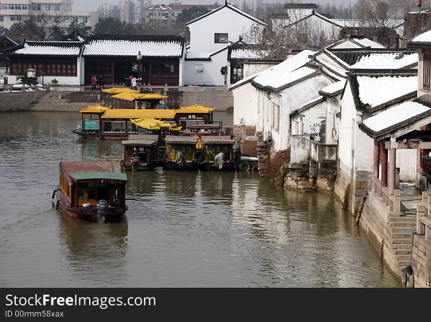 The beautiful and enjoyable snow scenery in the winter in the southern part of China. These sceneries are famous for their snow ,water, houses,and the blue sky.They are typical of the south in China.This picture is taken in the place of interest“Mooring by the Feng Bridge at night” in Suzhou ,China.