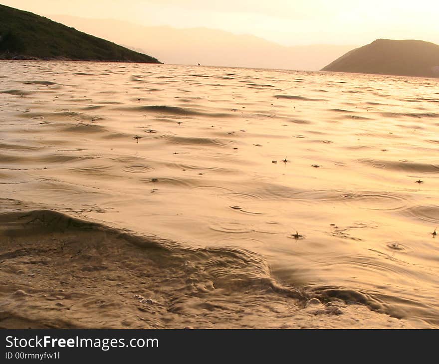 Beautiful sunset on the beach during the rain