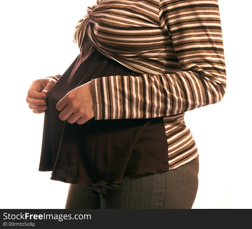 The pregnant woman on a white background. In hands holds small boots